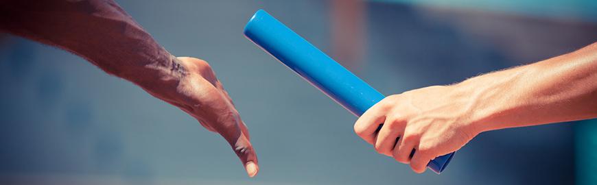 Un baton de relai passe d'une main à une autre. Fotolia/William87